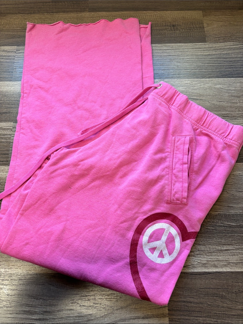 vintage pink lounge sweatpants featuring a heart-shaped peace sign graphic